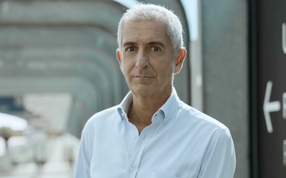 Santiago Quiroga standing on pavement with grey beams in background