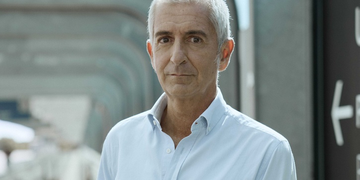 Santiago Quiroga standing on pavement with grey beams in background