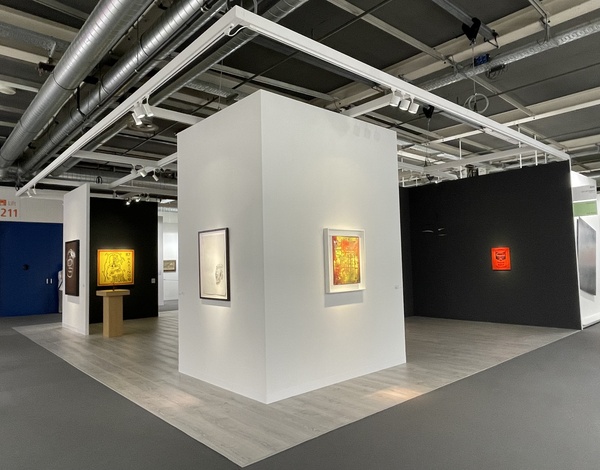 white exhibition wall with paintings inside big even hall with grey latex free carpet