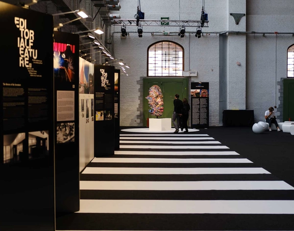 Brussels expo event hall with black and white striped carpet pathway